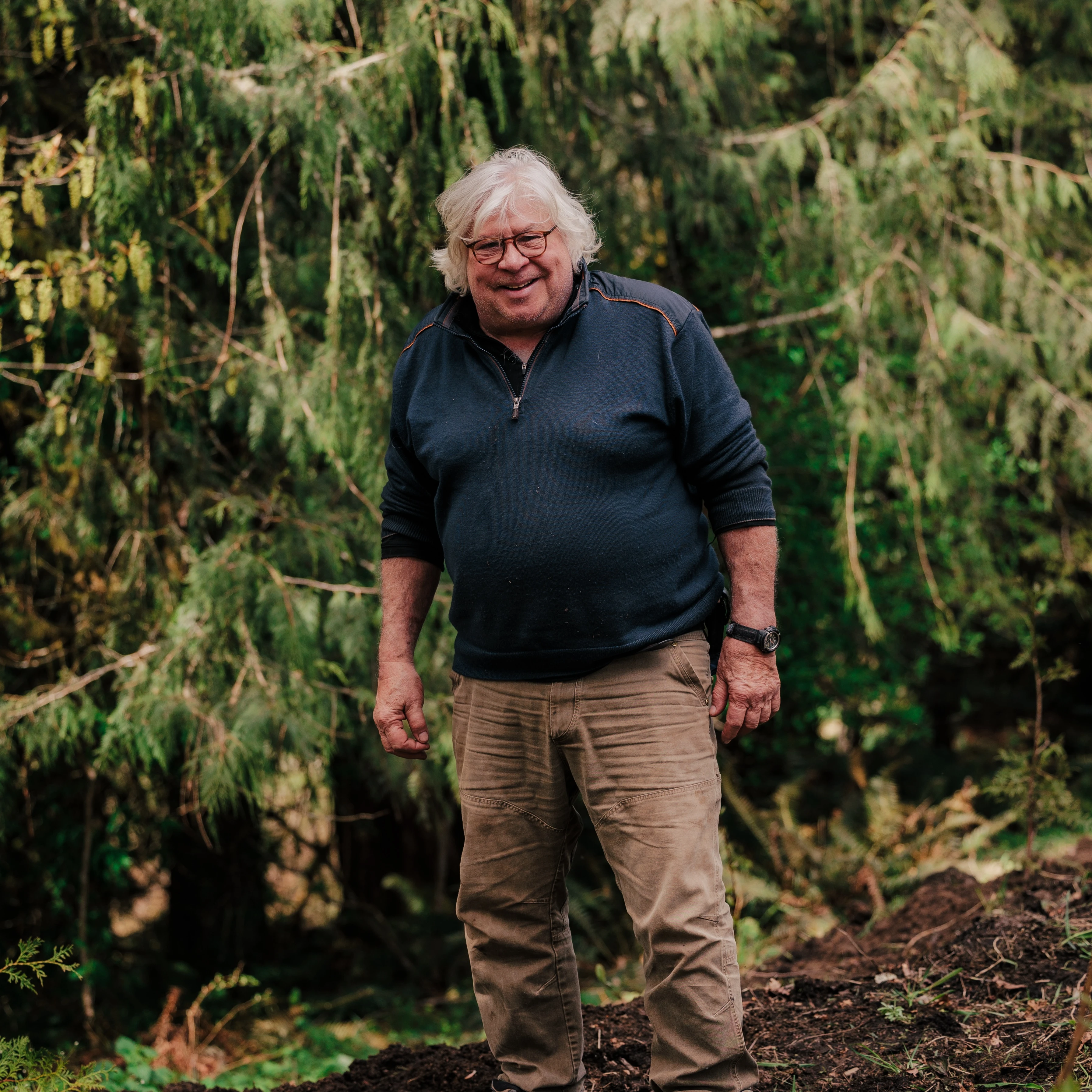 Ecologist, Lyndon C Lee, at Earth Funeral examining soil for environmental sustainability.